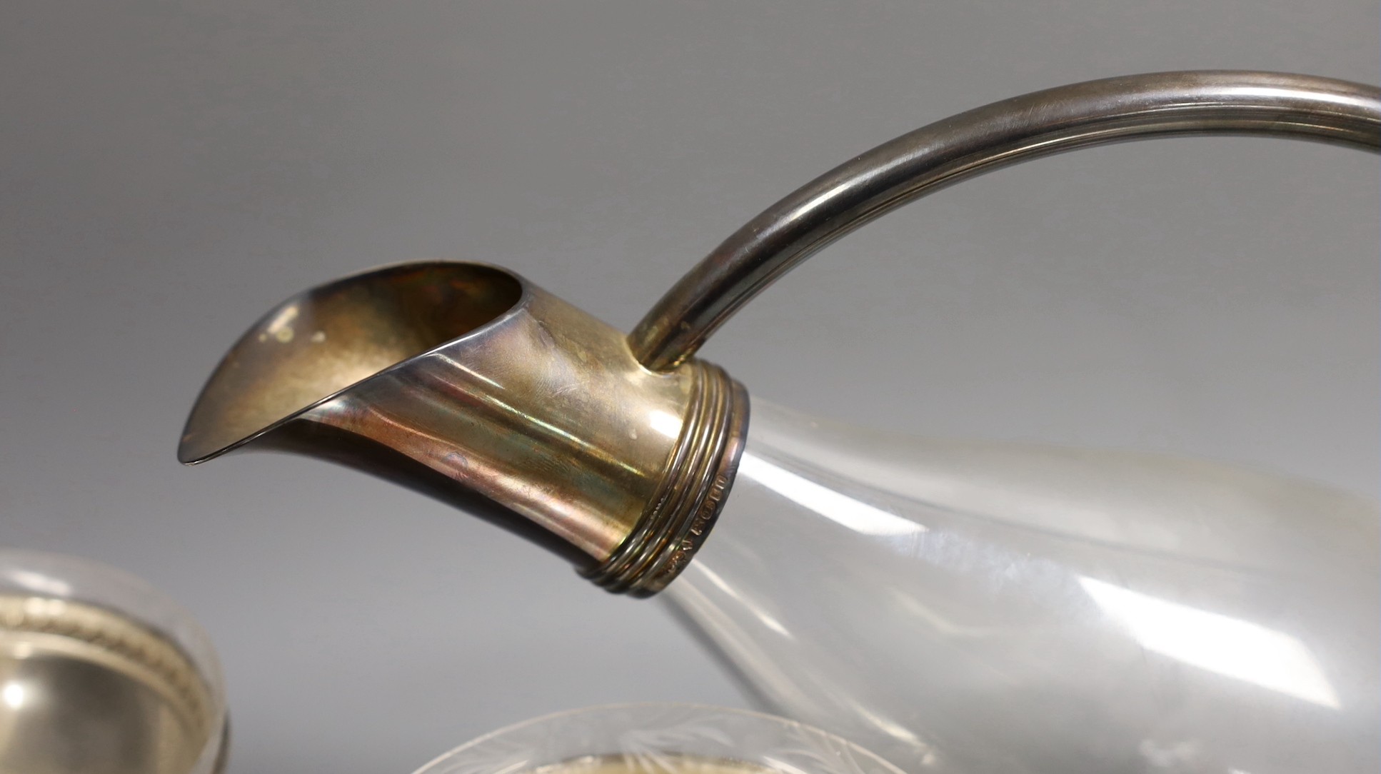 A set of eight sterling dessert coupes with glass inserts, height 6mm, together with a modern silver mounted decanter, by Asprey & Co Ltd (lacking stopper - one glass insert missing)